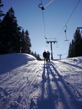 drag lift in Tirol, Austria.  lift with people up to mountain.