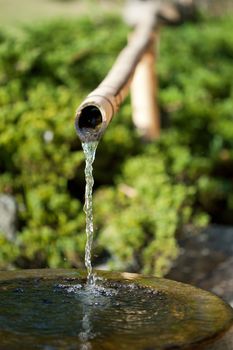 Bamboo tube and flowing water