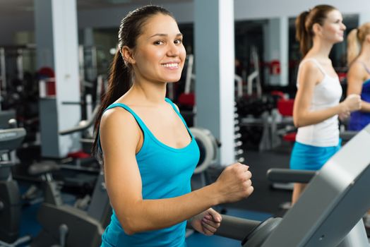 young women running on a treadmill, exercise at the fitness club