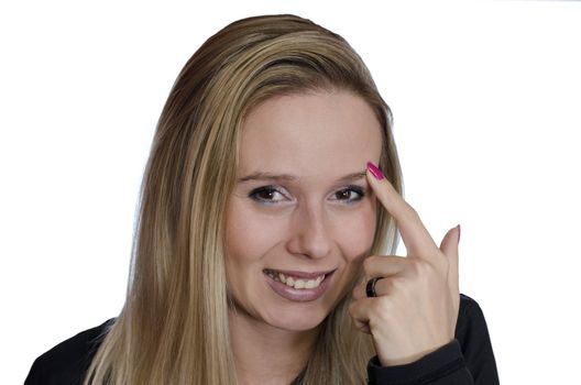 portrait of a young woman smiling putting finger on her eyebrow on white background