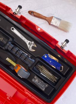 Orange Tool Box with Crescent Tape Brush Boxcutter Screws and Multi Purpose Tool