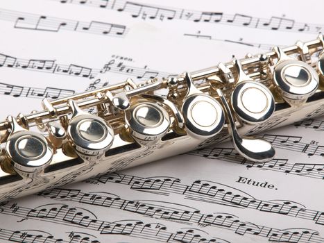  used flute rests across an open musical score. Only one line of music is in focus.