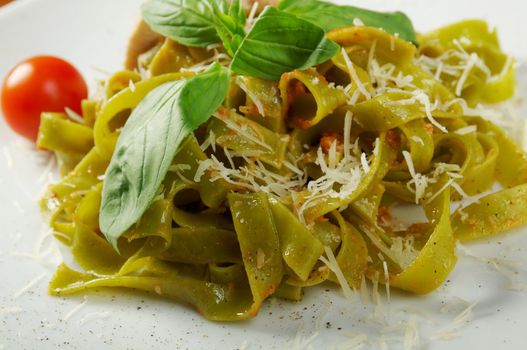 Pasta tagliatelle with pesto sauce basil and grated parmesan