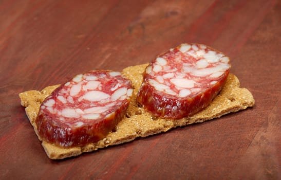 Salami and bread. close up with washed away by back background