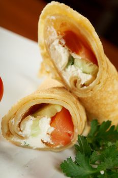 rolled pancakes stuffed chicken. Shallow depth-of-field.