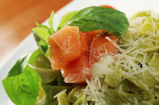 Pasta tagliatelle with pesto sauce basil and salmon