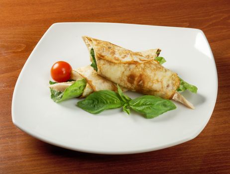 rolled pancakes stuffed chicken. Shallow depth-of-field.