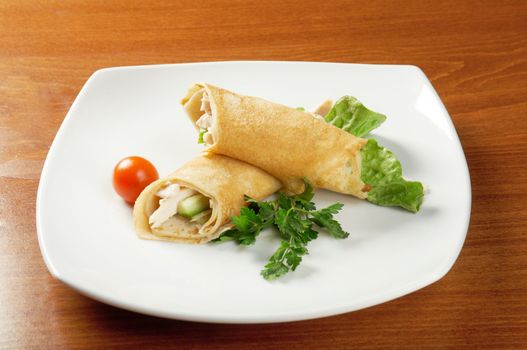 rolled pancakes stuffed chicken. Shallow depth-of-field.