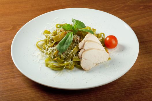 Pasta tagliatelle with pesto sauce basil and grated parmesan