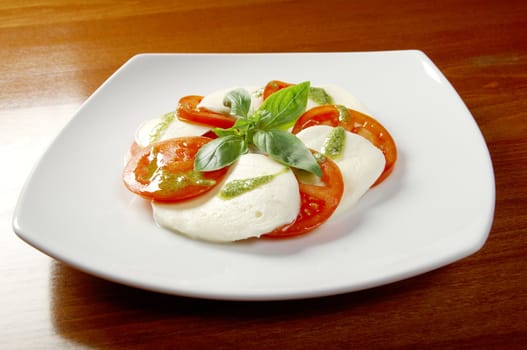 Italian cuisine.Arrangement of mozzarella and tomatoes