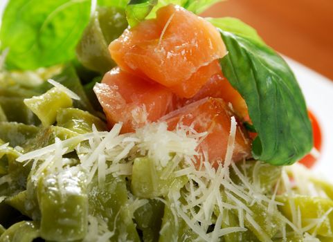 Pasta tagliatelle with pesto sauce basil and salmon