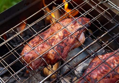 barbecue.chicken on the grill with flames