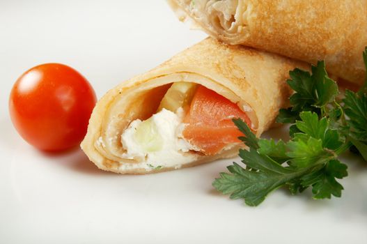 rolled pancakes stuffed chicken. Shallow depth-of-field.