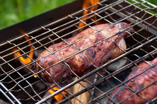 barbecue.chicken on the grill with flames