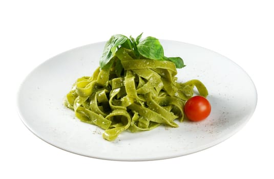 Tagliatelle pasta with pesto on light plate. closeup
