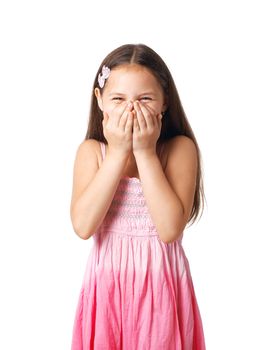 Portrait of a little girl hiding her smile in her hands.