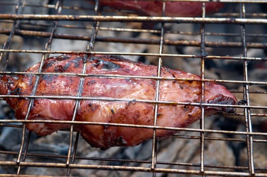 barbecue.chicken on the grill with flames