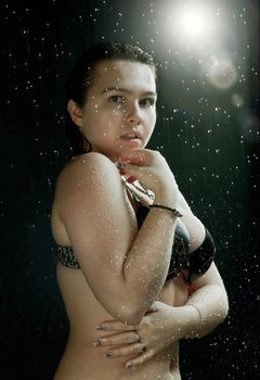 Young sexy woman water studio portrait.
