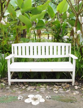 white bench made of wood in the garden