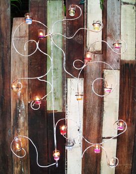 aromatic candle and wooden wall background