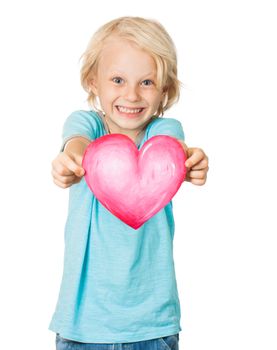 A very cute young blond boy smiling and holding out a love heart. Isolated on white.