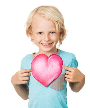 Portrait of a very cute young boy smiling and holding out a love heart. Isolated on white.