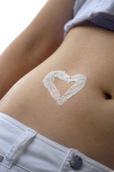 Belly with heart shape made from moisturizer