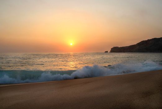 Beautiful sea sunset, waves and empy beach
