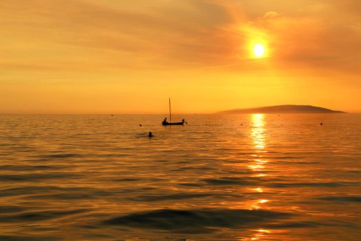 Wonderful sea sunset in Croatia and ship silhouette 