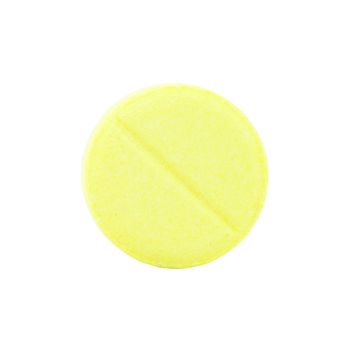 close-up of single yellow pill on white background