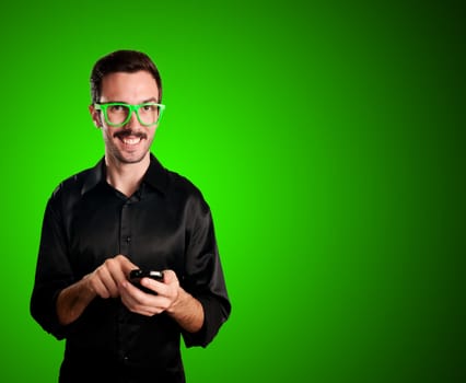 happy man holding phone on green background