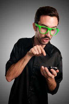 funny man holding phone on gray background