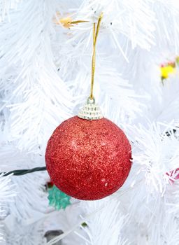 red christmas ball decoration on the white chrismas tree