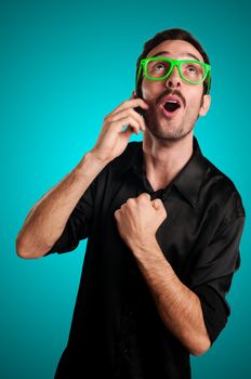 success man holding phone on blue background