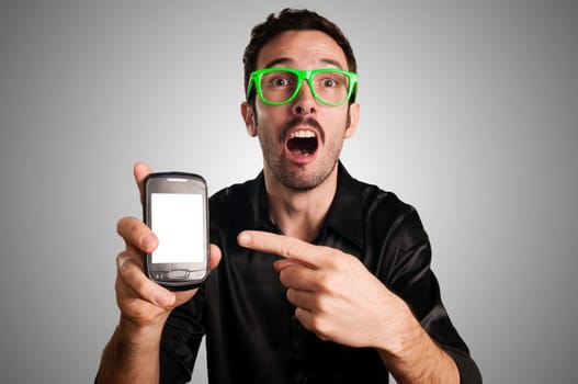 funny man showing phone on gray background