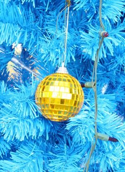 gold christmas ball decoration on the blue  chrismas tree