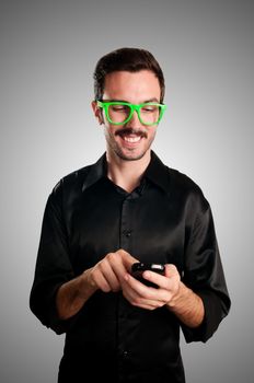 happy man holding phone on gray background