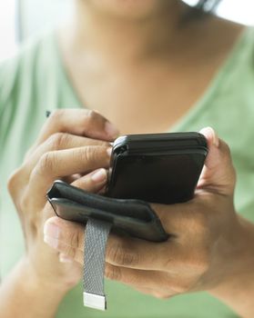 close up of a woman using her smartphone or cellphone.