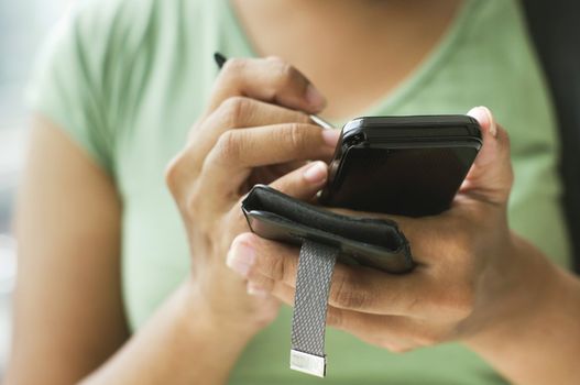 close up of a woman using her smartphone or cellphone.