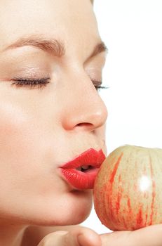 Woman puckering lips against apple