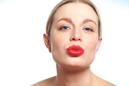 Closeup of a female model puckering her red hot lips.