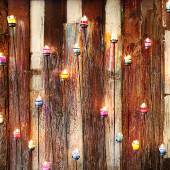 aromatic candle and wooden wall background