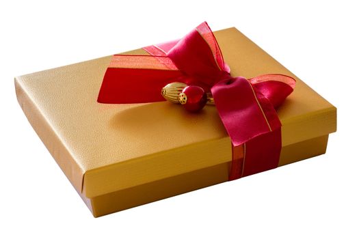 Isolated gold colored cardboard gift box on white background with red ribbon bow and decorations