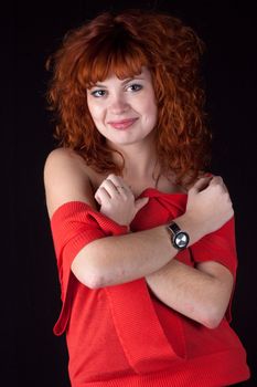 Portrait of beautiful redhead girl on black background