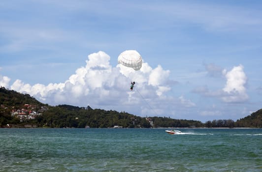 Para sailing amid clouds. Phuket. Patong. Fun for courageous people.