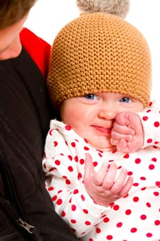 A newborn baby girl with her parents in the studio for a portrait.