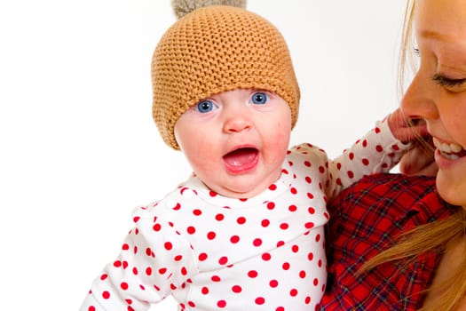 A newborn baby girl with her parents in the studio for a portrait.