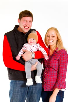 A family portrait of three people in the studio including mother father and newborn baby girl.