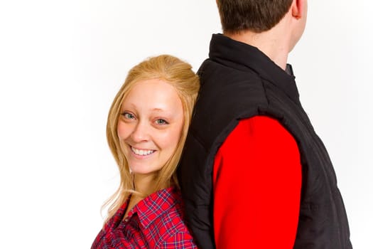 An attractive couple is photographed for a studio portrait on a white background.