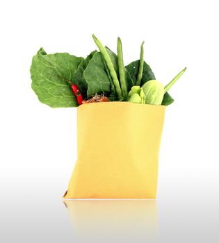 Assorted vegetables in brown bag with shadow